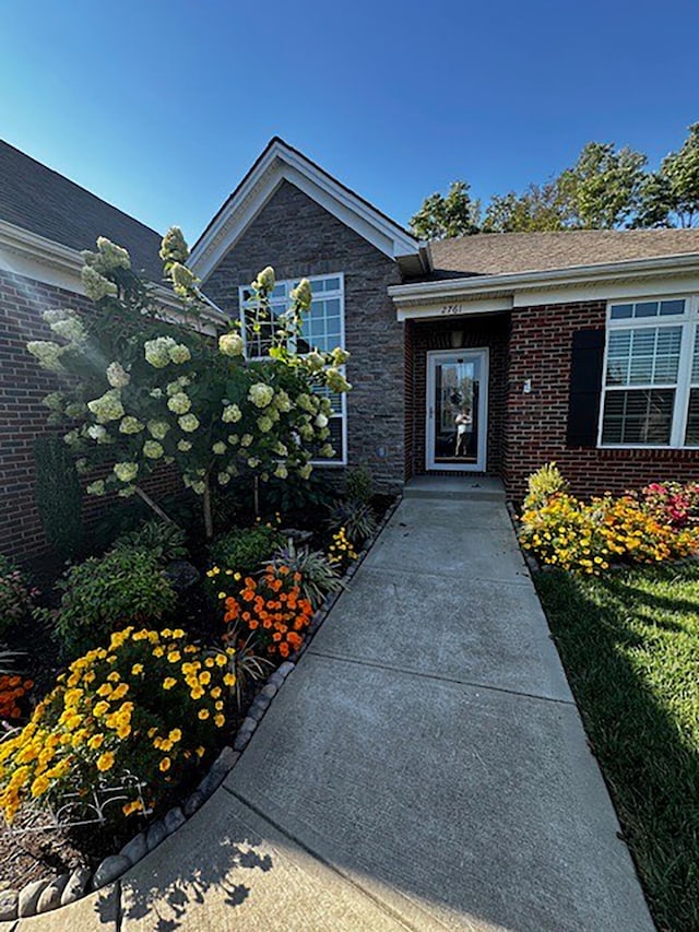 entrance to property featuring brick siding