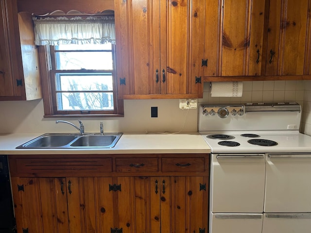 kitchen featuring range with two ovens, backsplash, brown cabinets, light countertops, and a sink