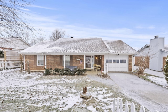 ranch-style house with brick siding, a shingled roof, fence, a garage, and driveway