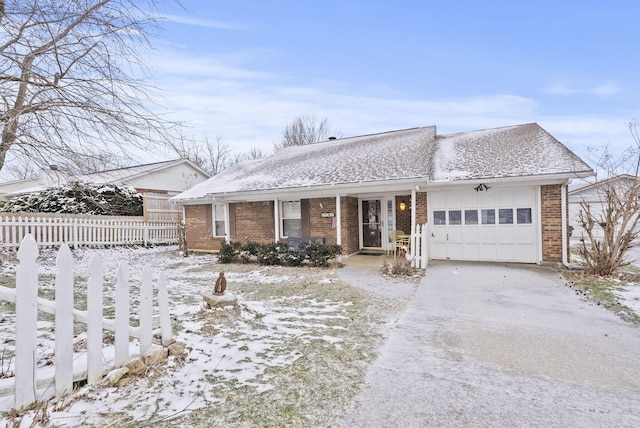 ranch-style house with brick siding, a shingled roof, fence, a garage, and driveway