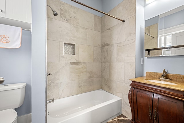 bathroom with toilet, shower / tub combination, and vanity