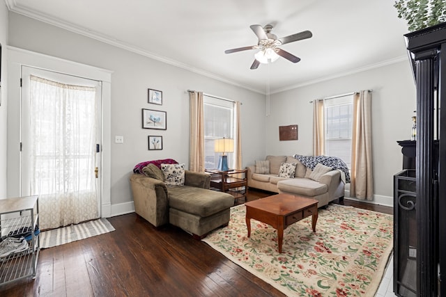 living area with a wealth of natural light, crown molding, and dark wood-style flooring