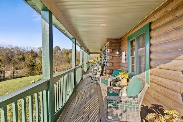 wooden terrace featuring covered porch