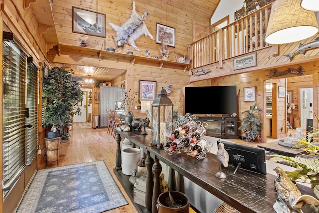 living room featuring wood walls, wood ceiling, high vaulted ceiling, and hardwood / wood-style flooring