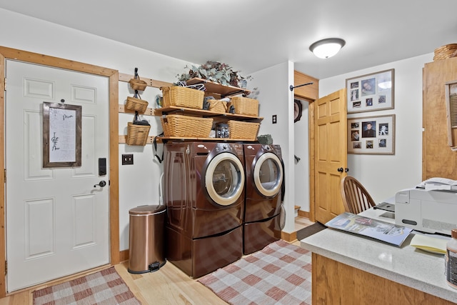 laundry area featuring light wood-type flooring, laundry area, and washer and dryer