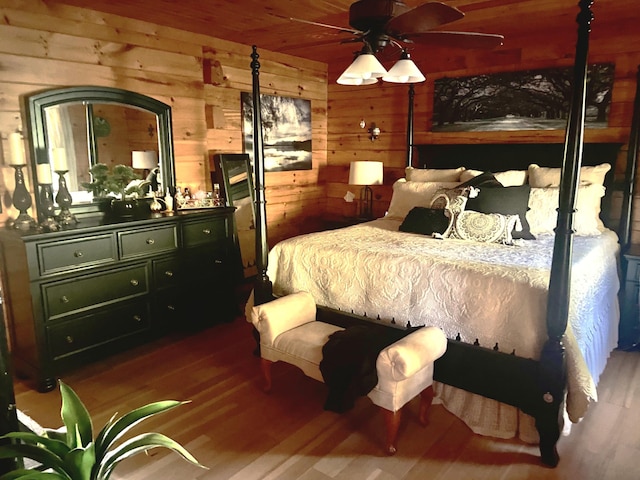 bedroom with wooden walls and wood finished floors