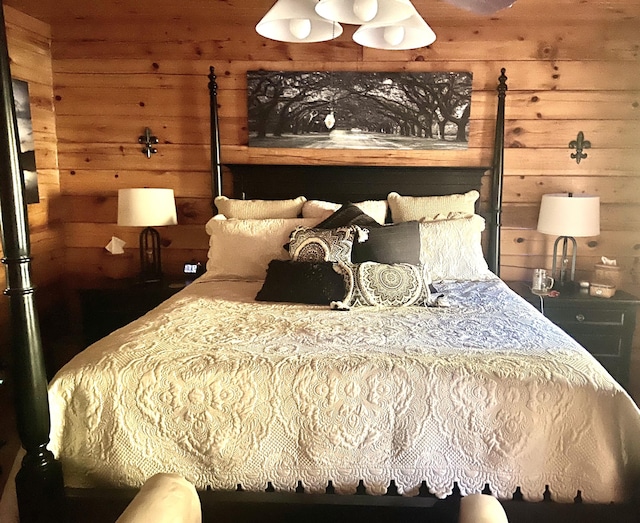 bedroom featuring wood walls