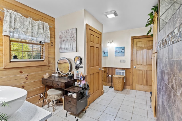 bathroom featuring wood walls, tile patterned floors, and wainscoting