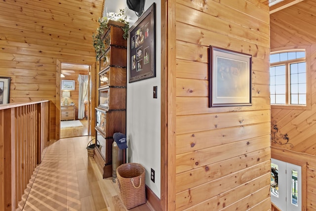 hallway featuring wooden walls