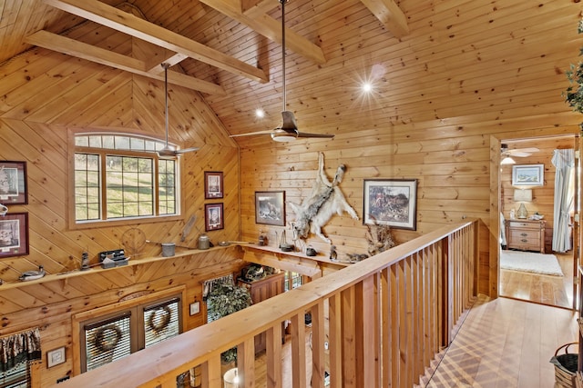 corridor with high vaulted ceiling, wood walls, wood finished floors, wood ceiling, and beamed ceiling