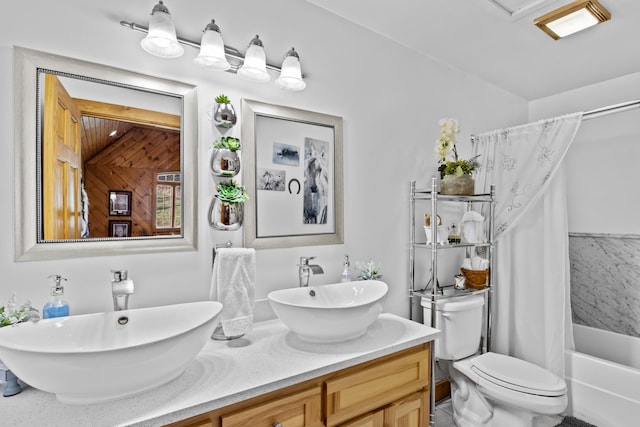 bathroom with double vanity, shower / tub combo, a sink, and toilet