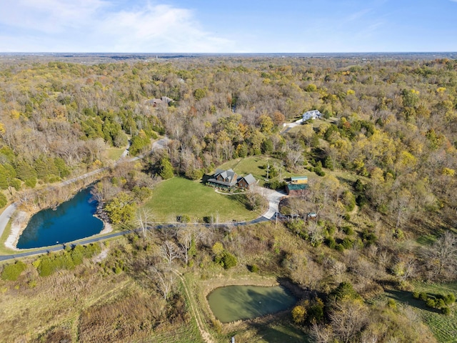 drone / aerial view with a water view and a wooded view