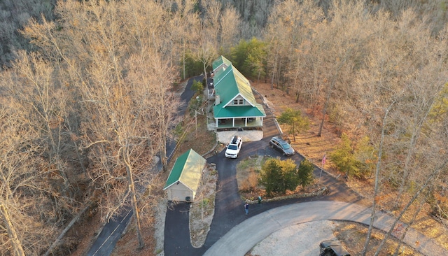 birds eye view of property featuring a view of trees