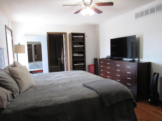 bedroom with dark wood finished floors, visible vents, and a ceiling fan