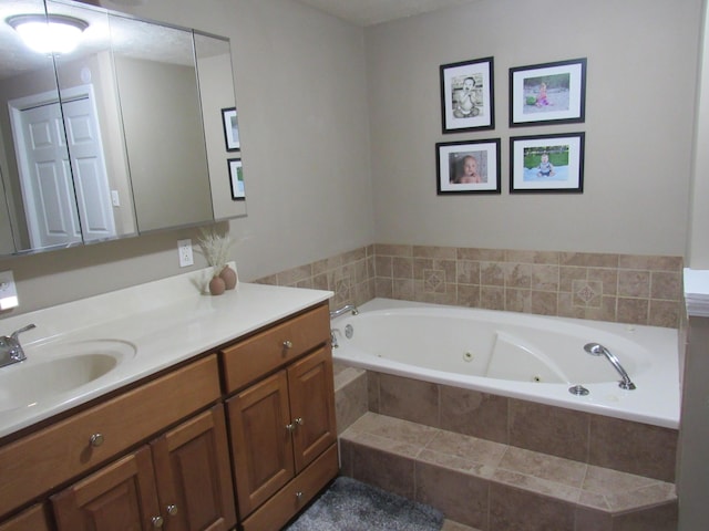 bathroom with a jetted tub and vanity