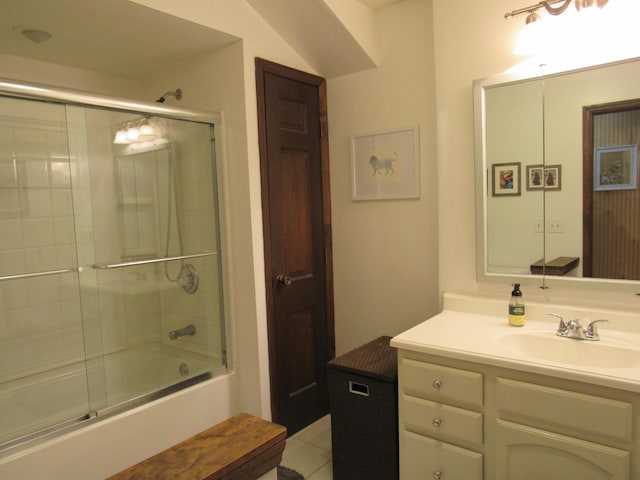 full bath featuring tile patterned flooring, combined bath / shower with glass door, and vanity