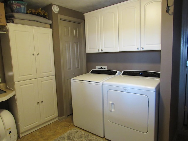 laundry room with cabinet space and washer and dryer