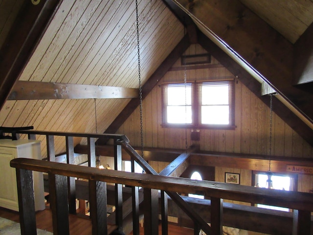 interior space featuring wood walls, wood ceiling, and beam ceiling