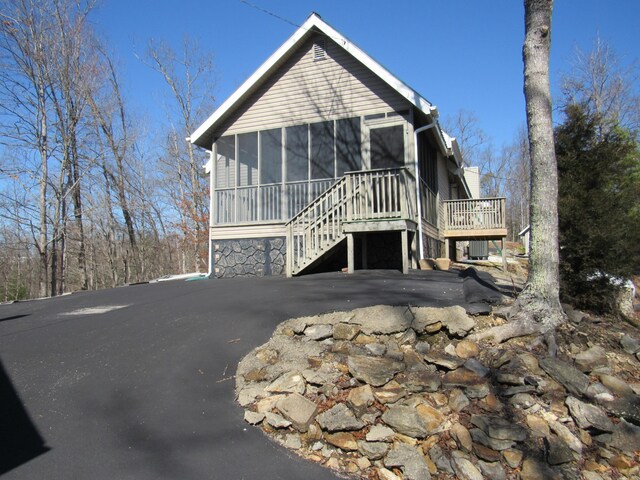 chalet / cabin featuring a sunroom and stairway