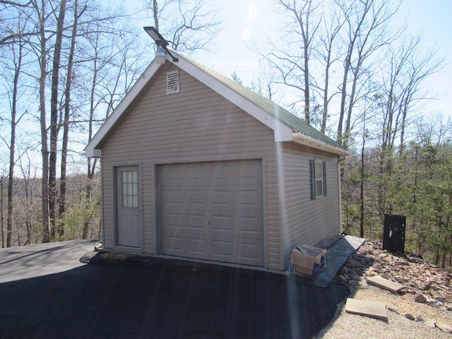 detached garage featuring driveway