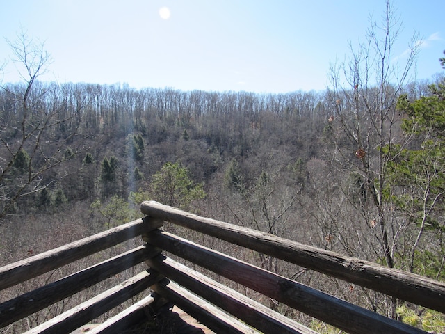 balcony featuring a forest view