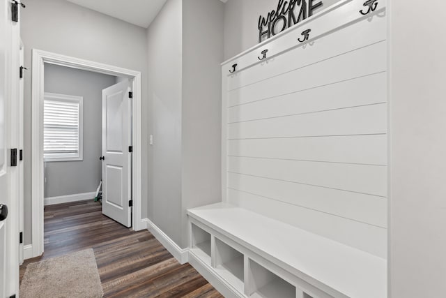 mudroom featuring dark wood-type flooring and baseboards