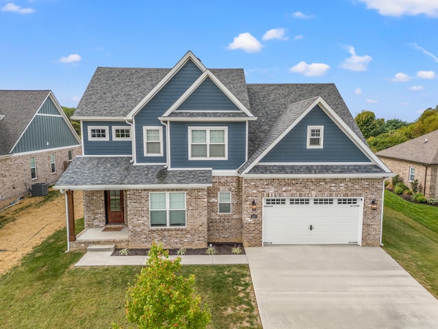 craftsman-style home featuring brick siding, roof with shingles, central AC, a front lawn, and driveway