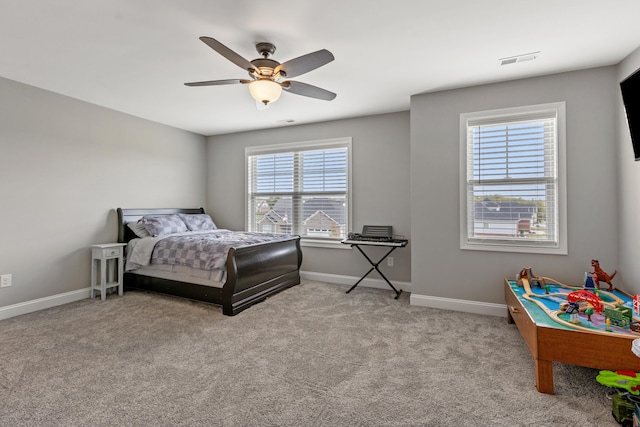 bedroom with light carpet, baseboards, visible vents, and ceiling fan