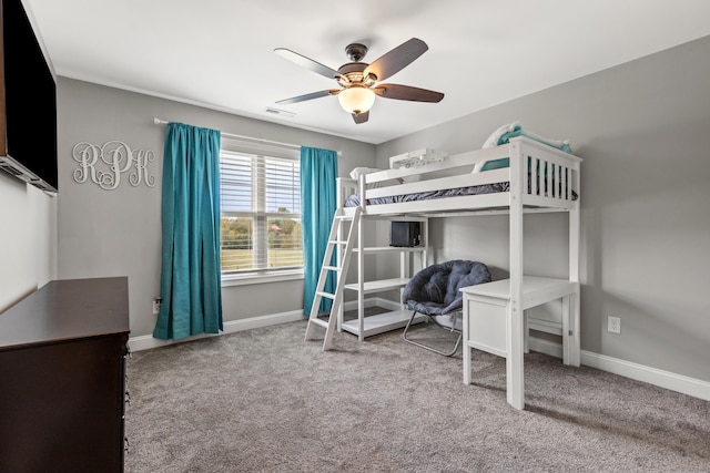 carpeted bedroom featuring baseboards and ceiling fan