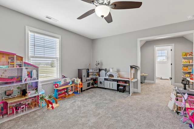 game room with light carpet, baseboards, visible vents, and ceiling fan