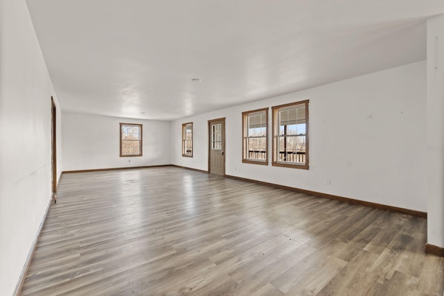 empty room featuring baseboards and wood finished floors