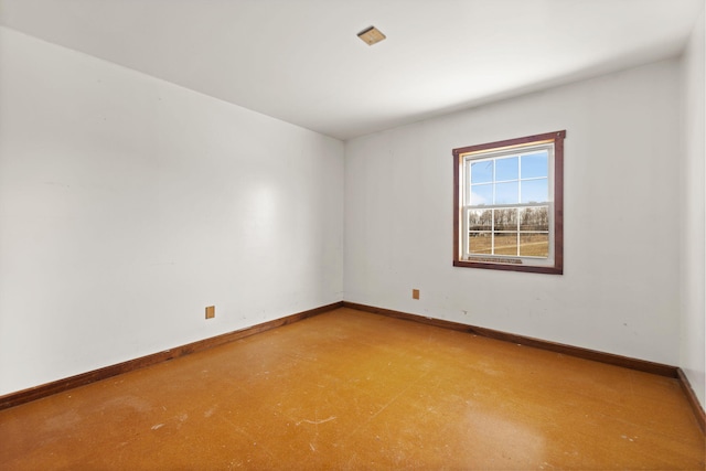 empty room featuring baseboards