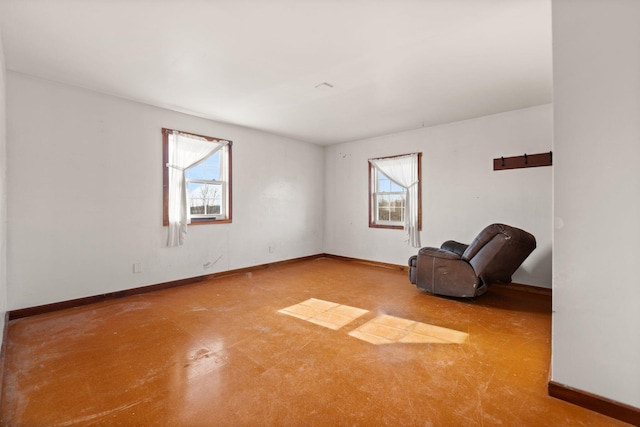 empty room featuring a healthy amount of sunlight and baseboards