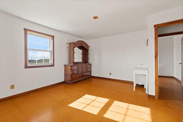 empty room with tile patterned floors and baseboards