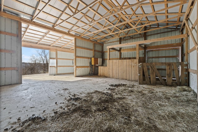 miscellaneous room with lofted ceiling and metal wall