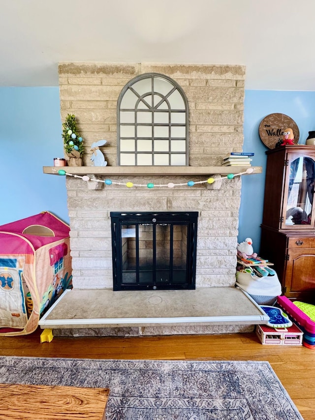 room details featuring a fireplace and wood finished floors