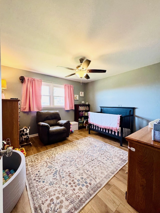 bedroom featuring wood finished floors and a ceiling fan