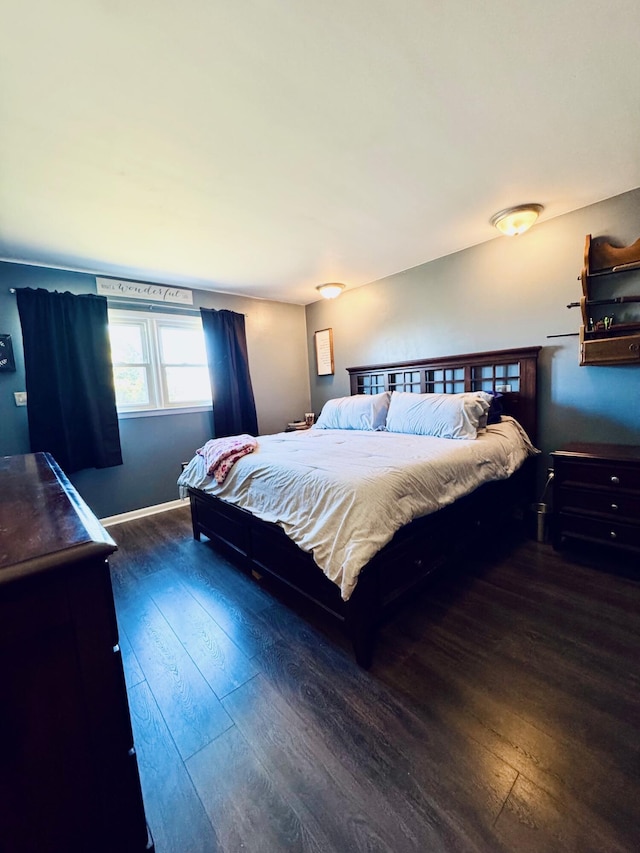 bedroom featuring wood-type flooring and baseboards