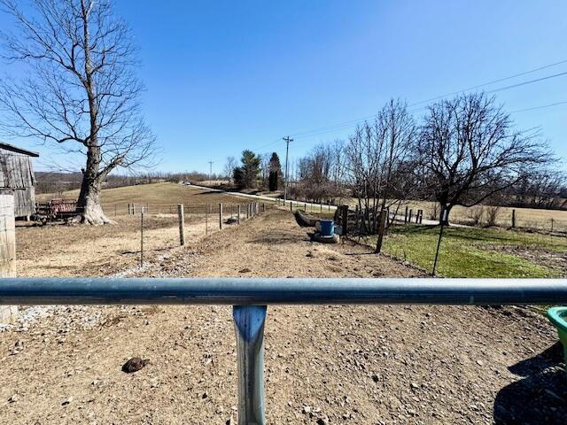 view of yard featuring fence and a rural view