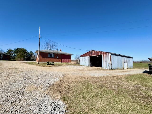 view of pole building featuring driveway