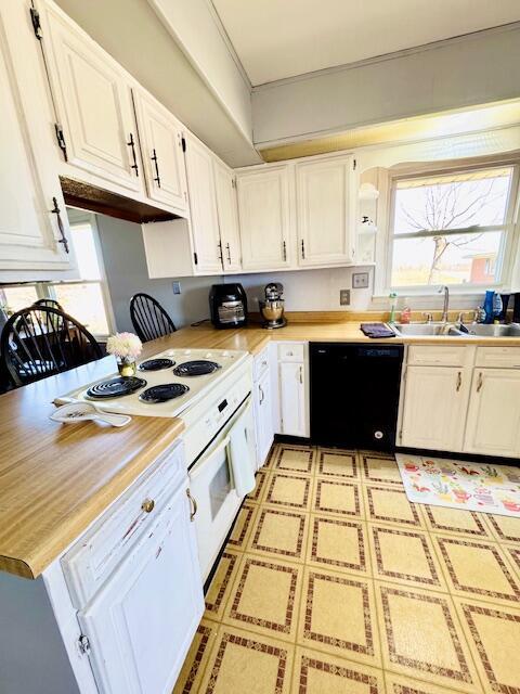 kitchen featuring white electric range oven, dishwasher, light countertops, white cabinetry, and a sink