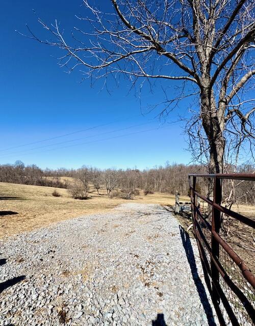 view of yard with a rural view and fence