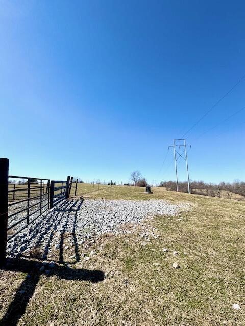 view of yard with a rural view and fence