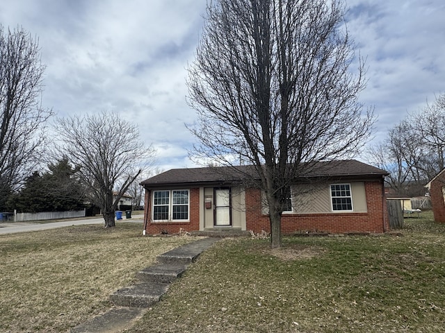 ranch-style home with brick siding and a front lawn