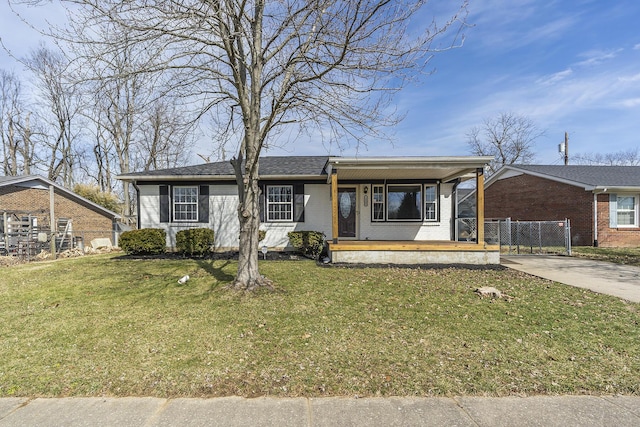 view of front of property with fence, a front lawn, concrete driveway, and brick siding