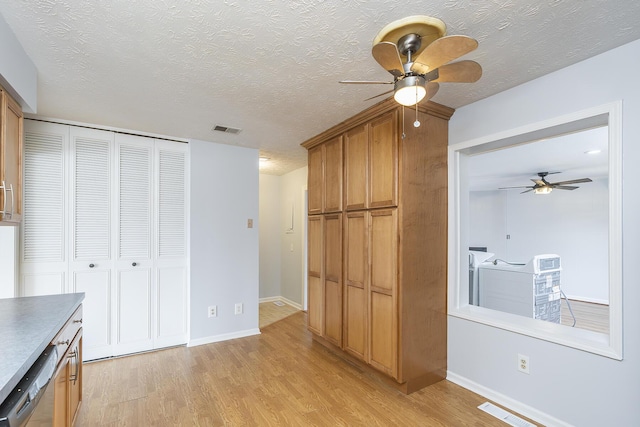 unfurnished bedroom with light wood finished floors, visible vents, and washer and clothes dryer