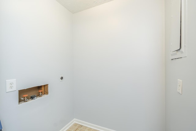 laundry area with laundry area, baseboards, a textured ceiling, washer hookup, and electric dryer hookup