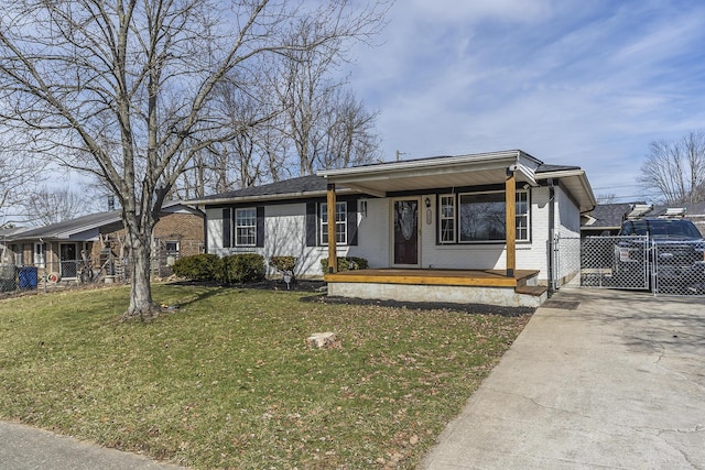 ranch-style house with a porch, brick siding, fence, driveway, and a front yard