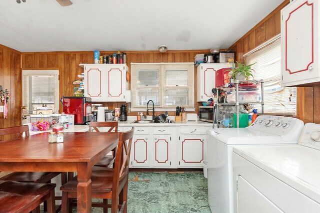 kitchen featuring light countertops, separate washer and dryer, and wooden walls