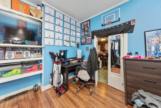 office space with crown molding, wood finished floors, and baseboards